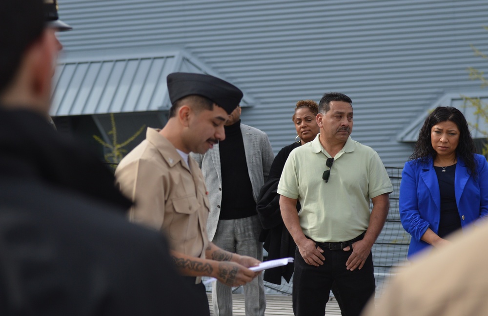 A touching moment during a re-enlistment ceremony aboard Battleship Wisconsin