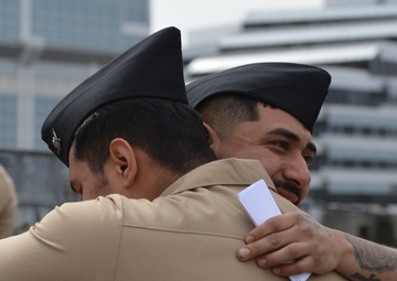 A touching moment during a re-enlistment ceremony aboard Battleship Wisconsin