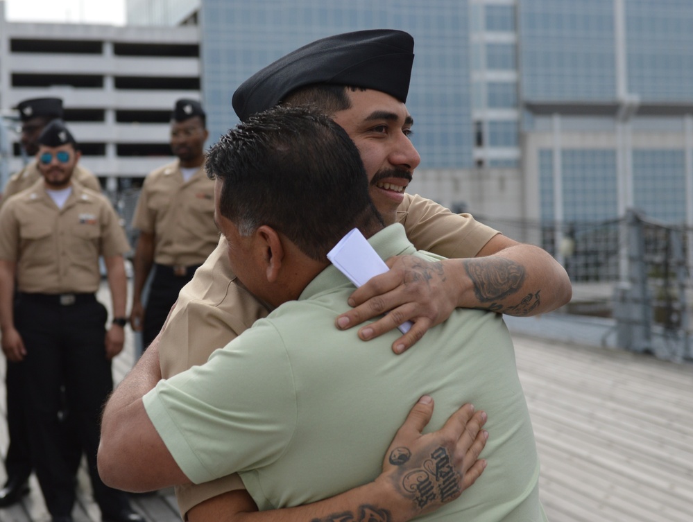 A touching moment during a re-enlistment ceremony aboard Battleship Wisconsin