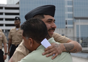 A touching moment during a re-enlistment ceremony aboard Battleship Wisconsin