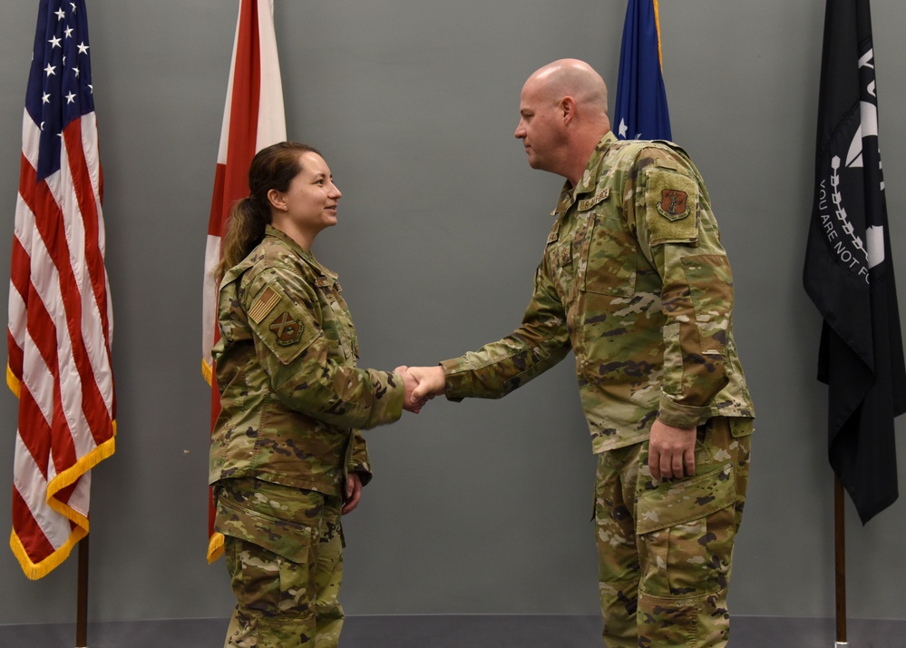 Command Chief coins Staff Sgt. Saquilan