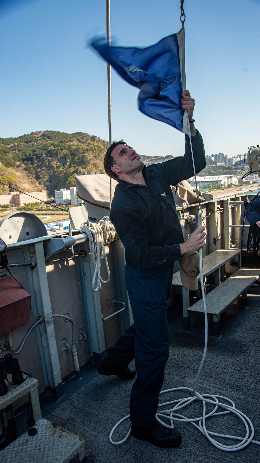 Sailor Lowers Signal Flags