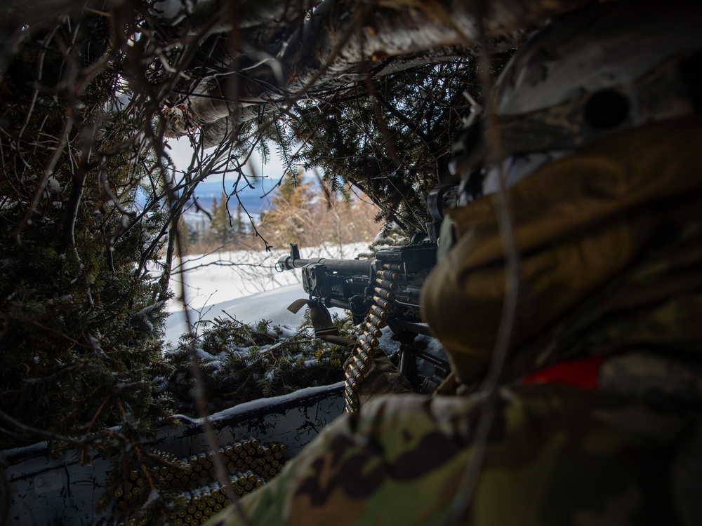 11th Airborne Division Soldier lines up his sight during JPMRC-AK 23-02