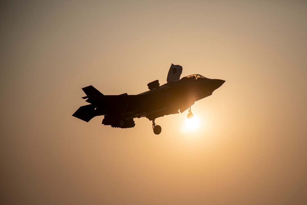 USS Makin Island flight deck operations during sunset