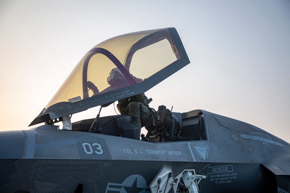 USS Makin Island flight deck operations during sunset