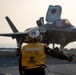 USS Makin Island flight deck operations during sunset