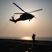 USS Makin Island flight deck operations during sunset