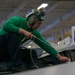 Sailor cleans jet aboard USS Carl Vinson (CVN70)