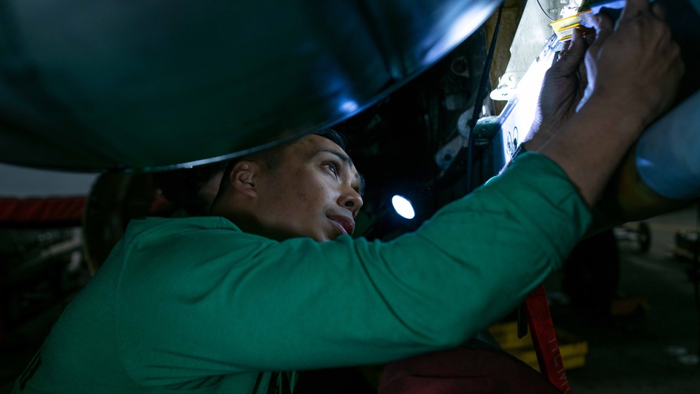 Sailor cleans jet aboard USS Carl Vinson (CVN70)