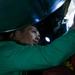 Sailor cleans jet aboard USS Carl Vinson (CVN70)