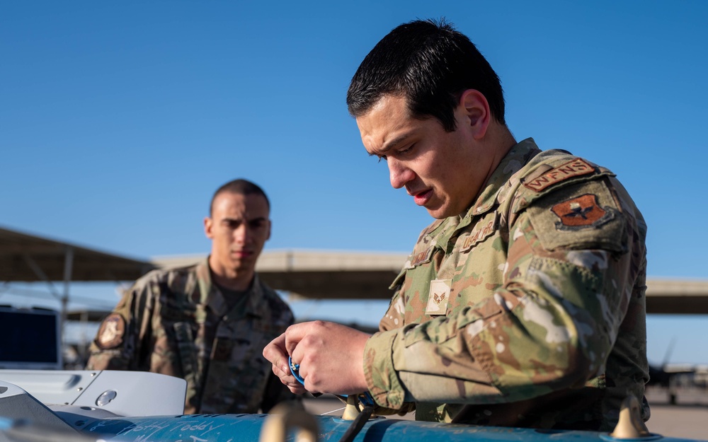 61st AMU loads HCC signed training bombs