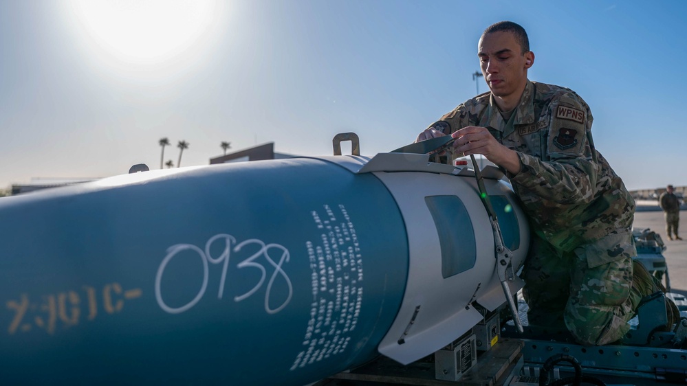 61st AMU loads HCC signed training bombs