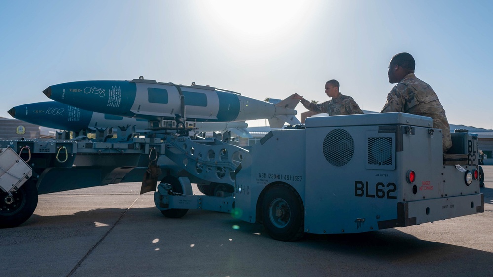 61st AMU loads HCC signed training bombs