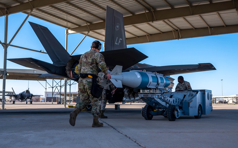 61st AMU loads HCC signed training bombs