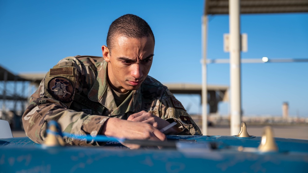 61st AMU loads HCC signed training bombs