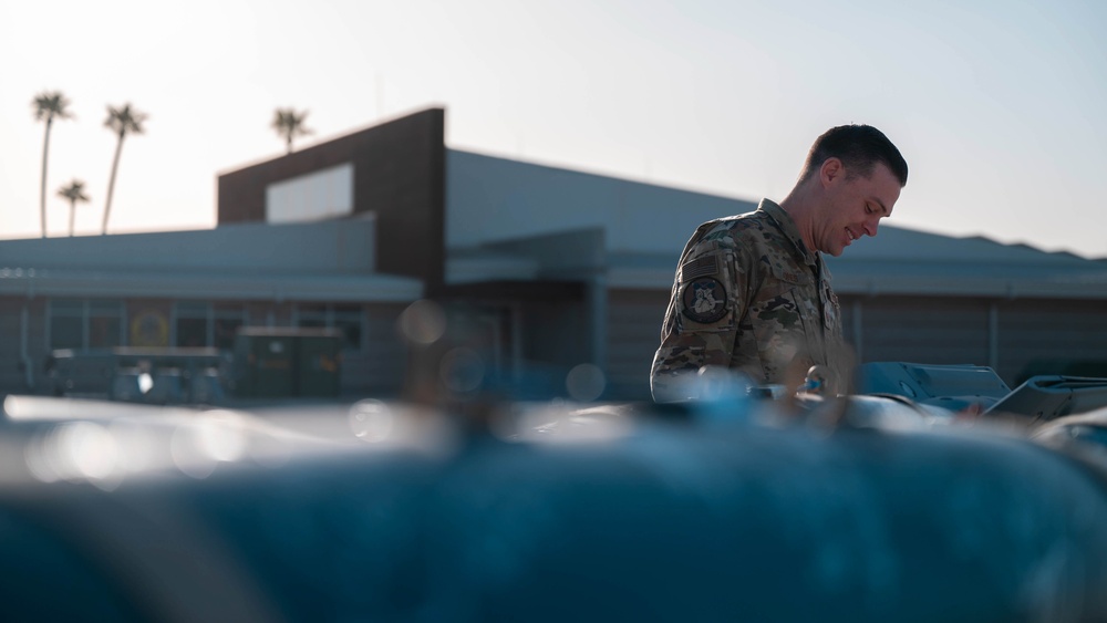 61st AMU loads HCC signed training bombs