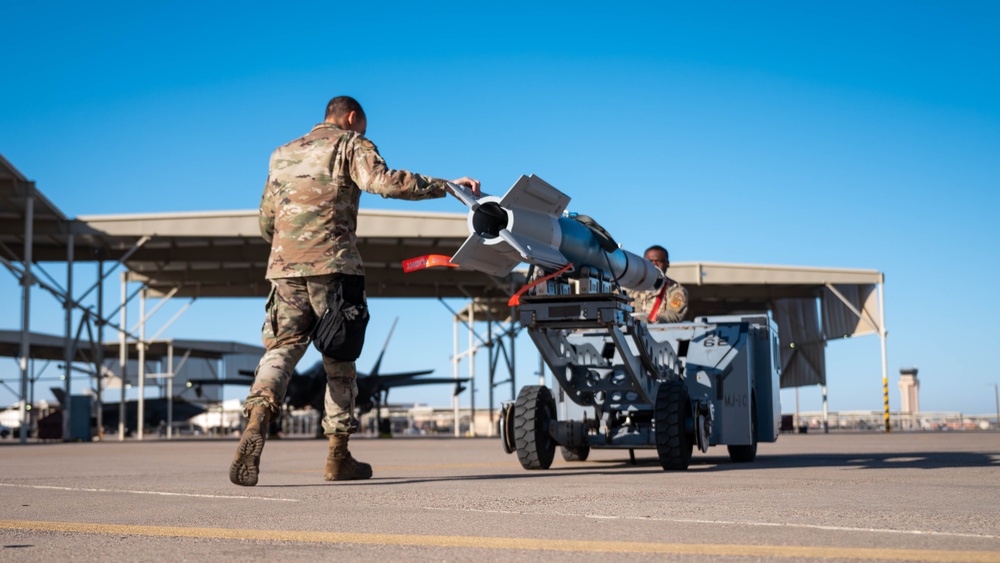 61st AMU loads HCC signed training bombs