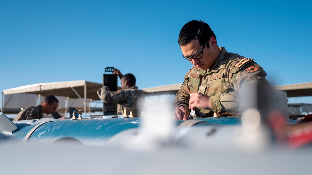 61st AMU loads HCC signed training bombs