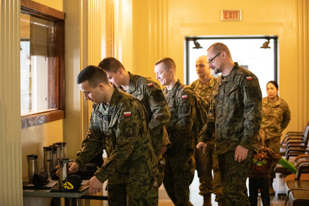 Soldiers from the Polish Territorial Defense Force present Bronze Polish Army Medals to ILARNG Soldiers