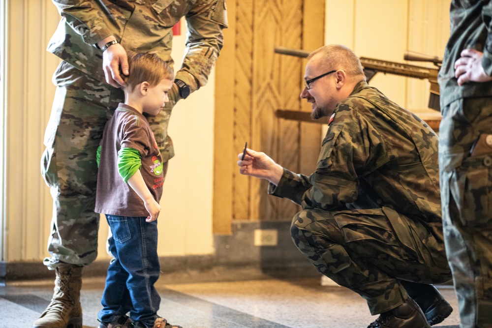 Soldiers from the Polish Territorial Defense Force present Bronze Polish Army Medals to ILARNG Soldiers