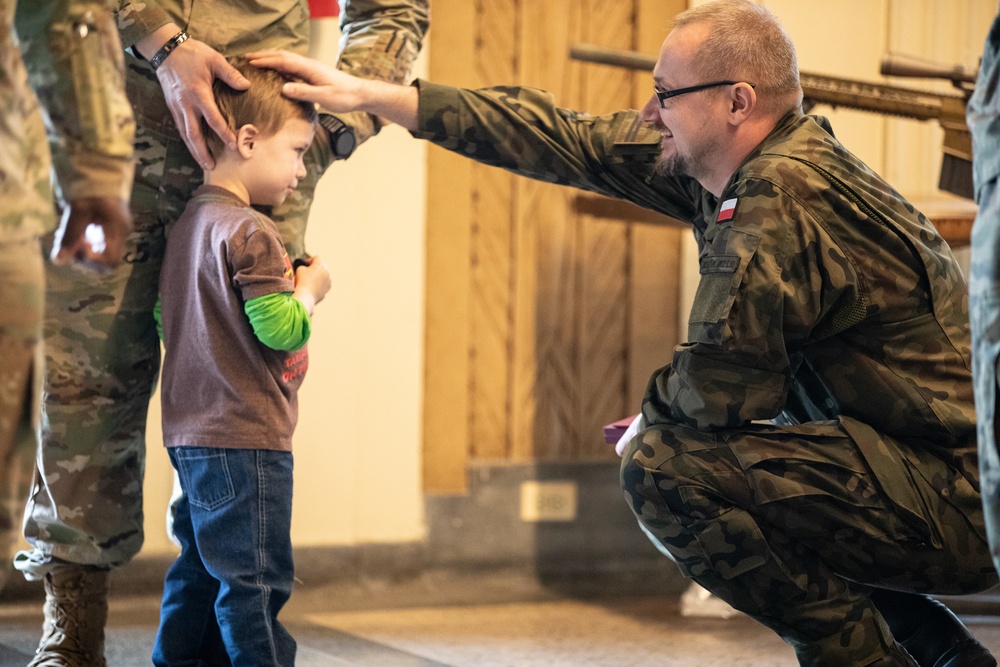 Soldiers from the Polish Territorial Defense Force present Bronze Polish Army Medals to ILARNG Soldiers