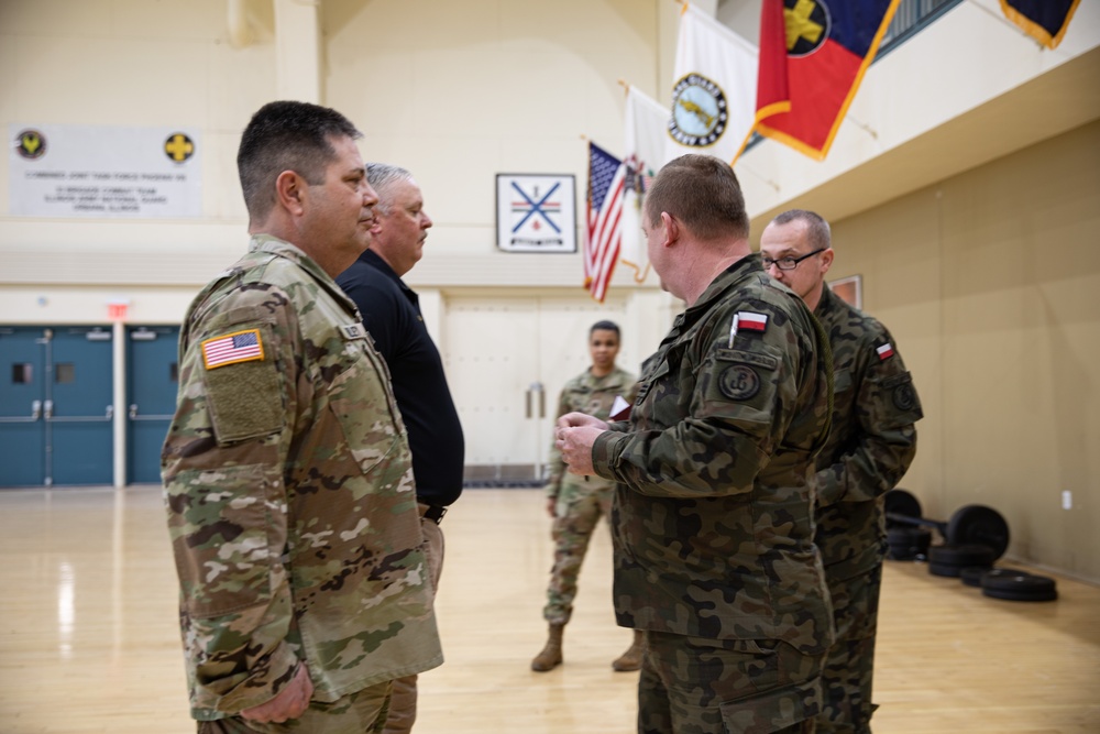 Soldiers from the Polish Territorial Defense Force present Bronze Polish Army Medals to ILARNG Soldiers