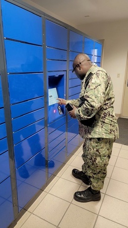 A resident of NAS Fallon BEQ uses the new Intelligent Mail Locker to pick up personal mail