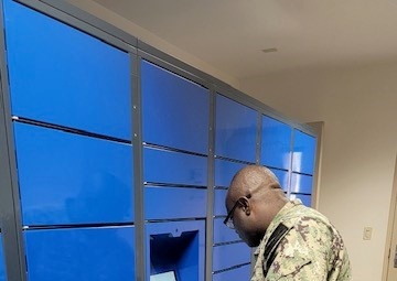 A resident of NAS Fallon BEQ uses the new Intelligent Mail Locker to pick up personal mail