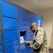 A resident of NAS Fallon BEQ uses the new Intelligent Mail Locker to pick up personal mail
