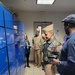 NAS Fallon Commanding Officer Capt. Shane Paul Tanner participates in a demonstration of the Intelligent Mail Locker in the NAS Fallon BEQ.