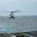 Helicopter Deposits Cargo On Flight Deck