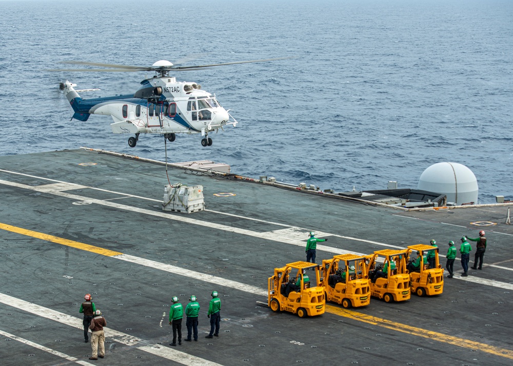 Helicopter Deposits Cargo On Flight Deck