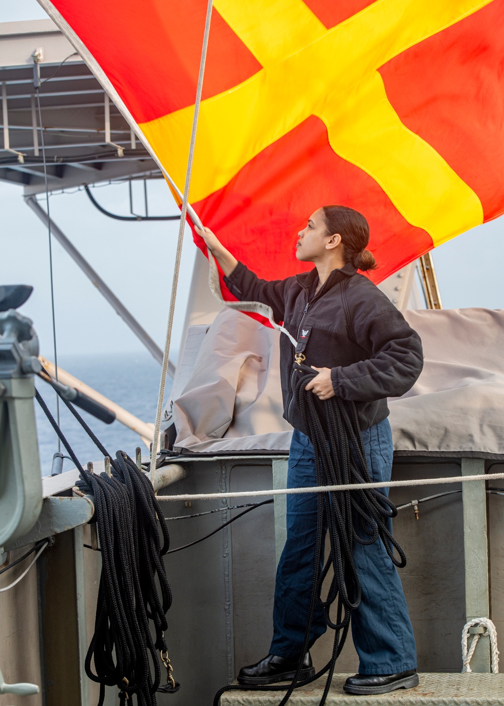 Sailor Stows Signal Flag