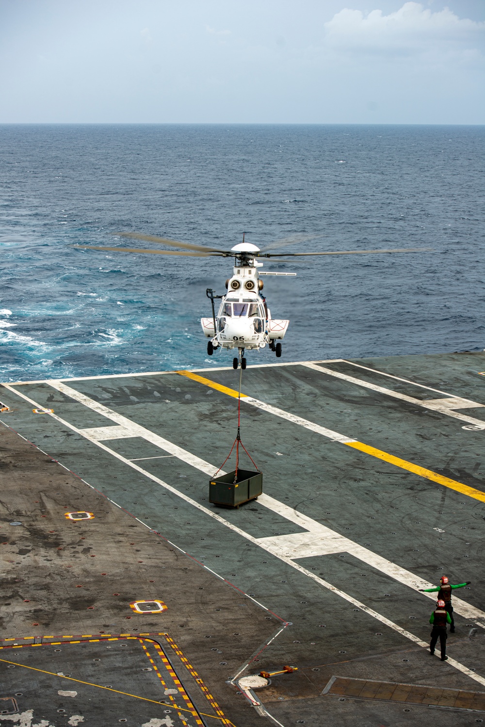 Helicopter Deposits Cargo On Flight Deck