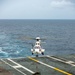 Helicopter Deposits Cargo On Flight Deck