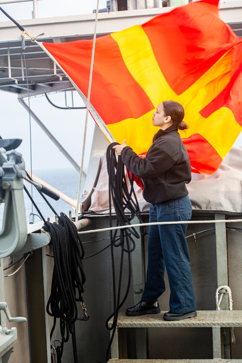 Sailor Stows Signal Flag