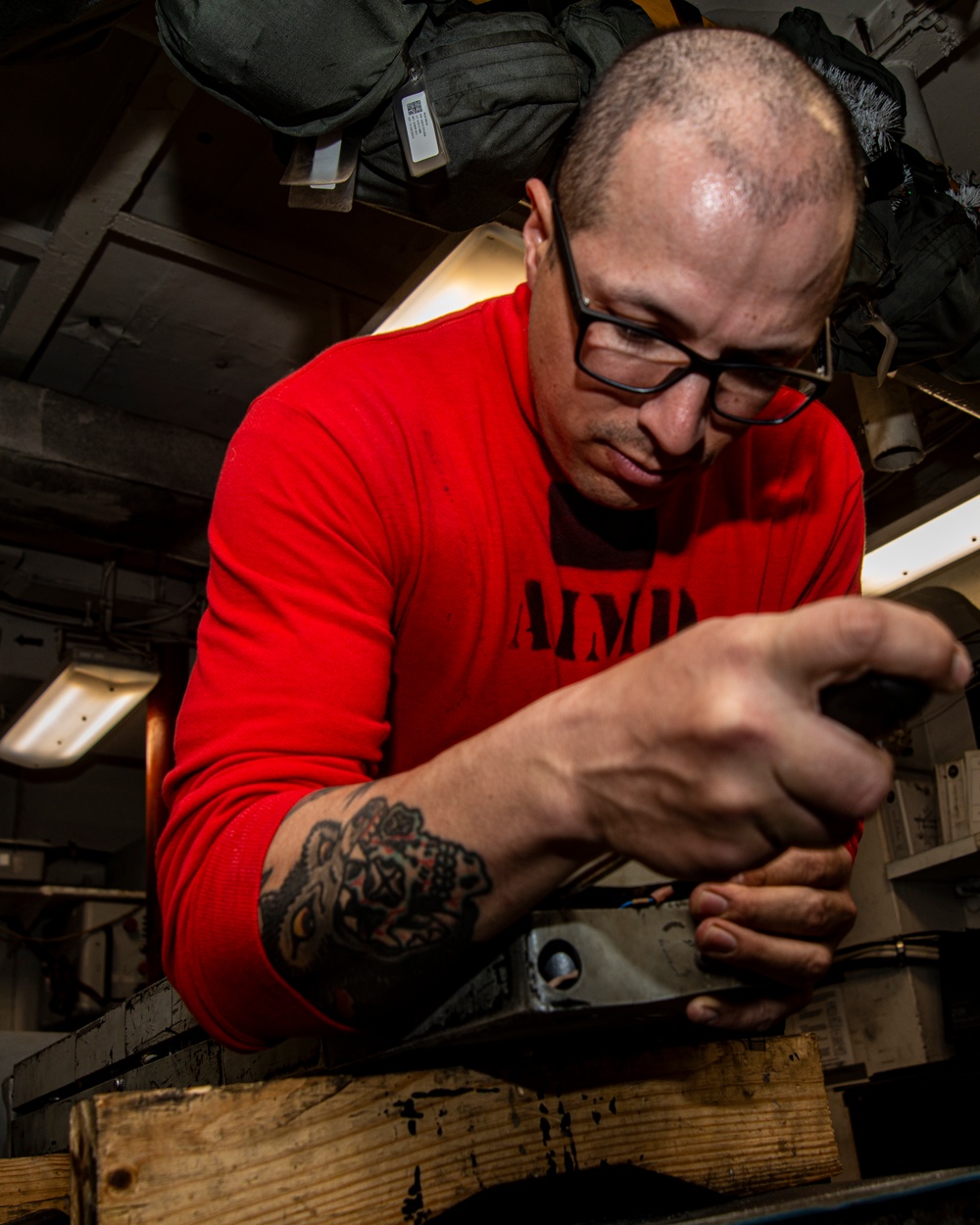 Sailor Disassembles Bomb Rack