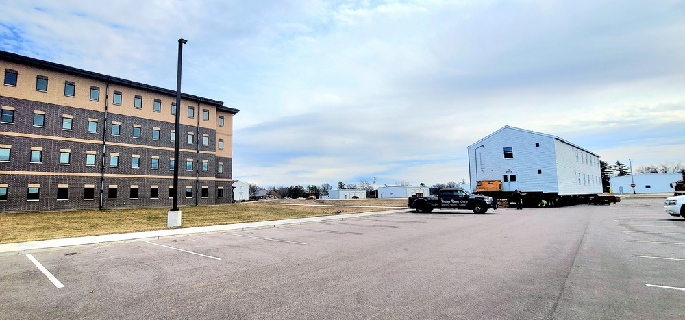 Contractors move third World War II-era barracks to new location