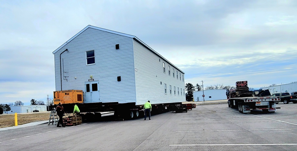 Contractors move third World War II-era barracks to new location