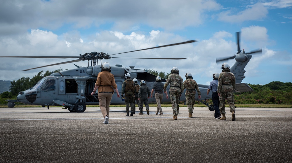 Logistics experts board a helicopter for an island flyover