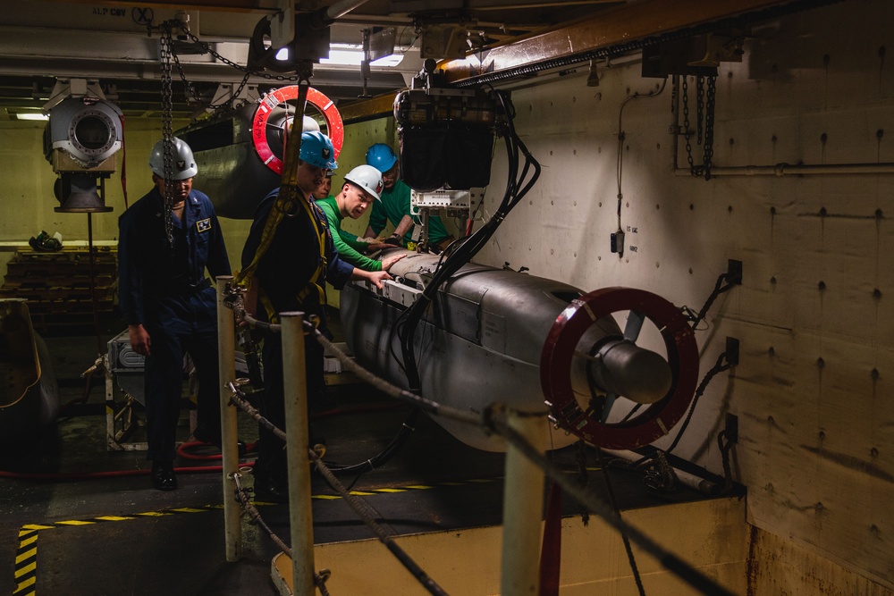 U.S. Sailors Lift Jamming Pod