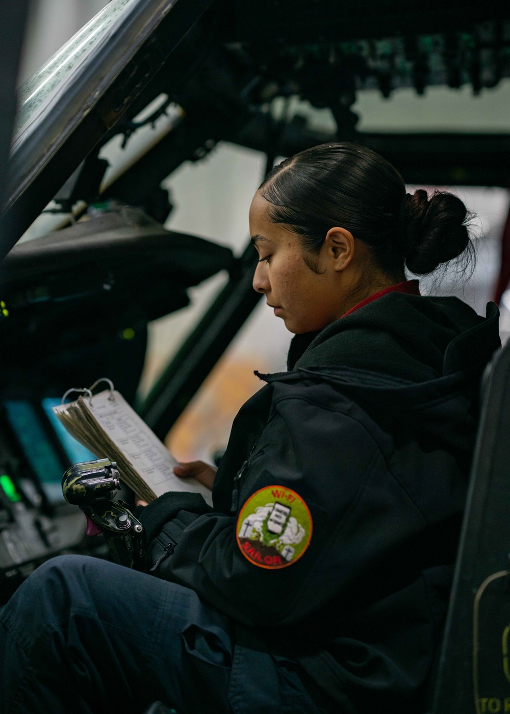 Sailor preforms systems check on a helicopter aboard USS Carl Vinson (CVN70)