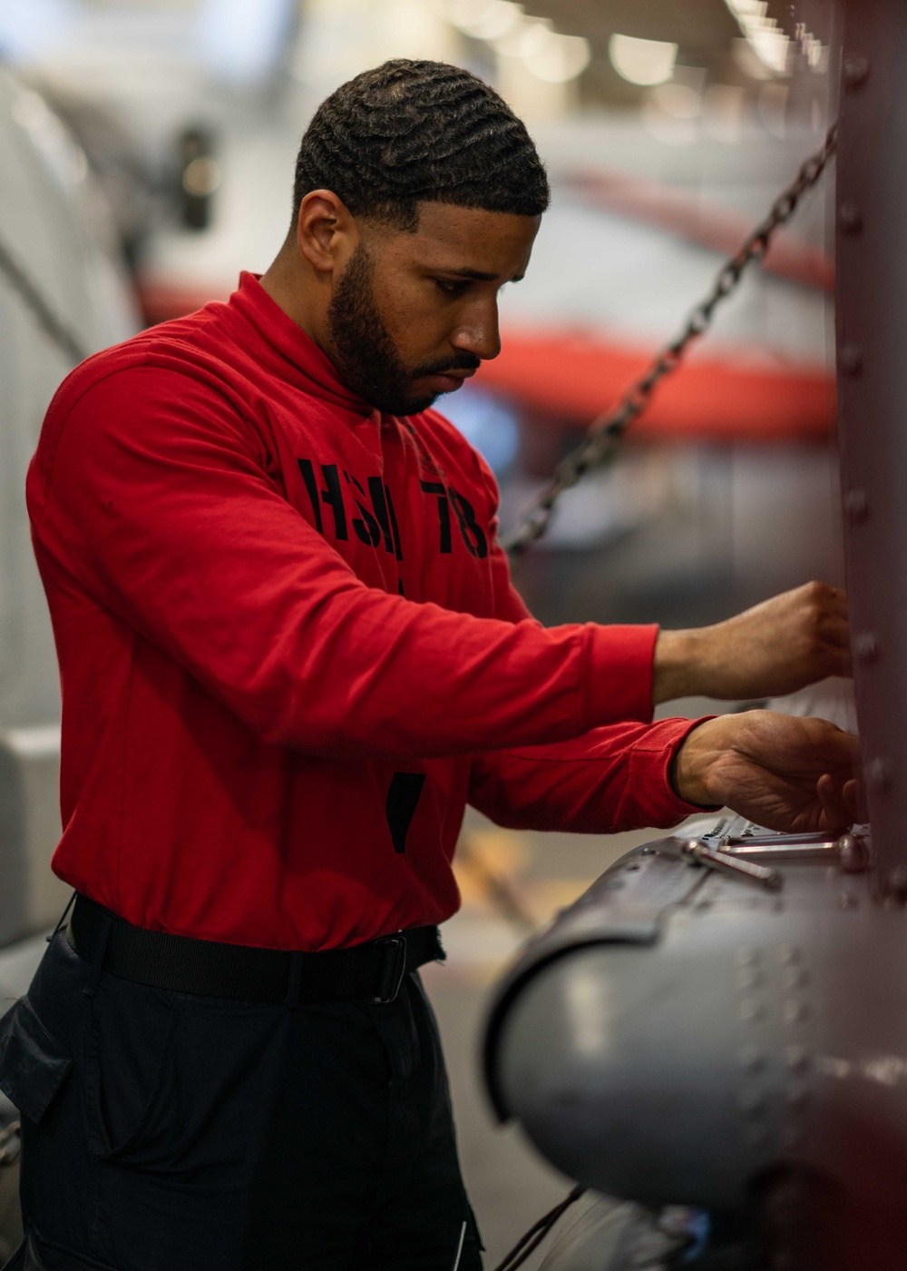 Sailor preforms maintenance on a helicopter aboard USS Carl Vinson (CVN 70)