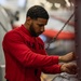 Sailor preforms maintenance on a helicopter aboard USS Carl Vinson (CVN 70)