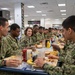 Rear Admiral Jennifer Couture eats lunch with recruits at Recruit Training Command