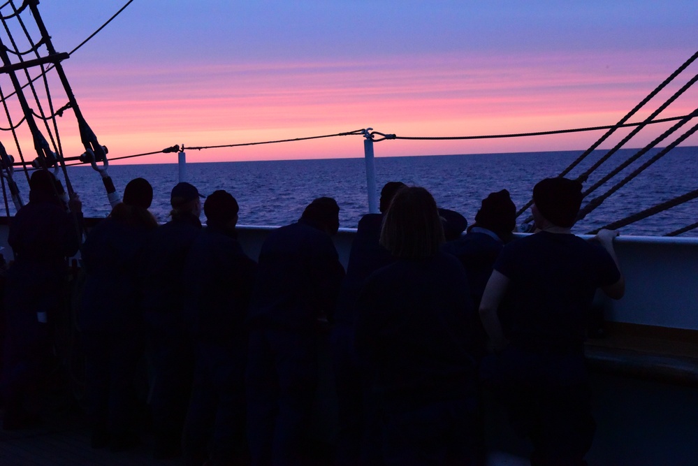 Coast Guard personnel aboard USCGC Eagle enjoy twilight while underway in the Atlantic Ocean