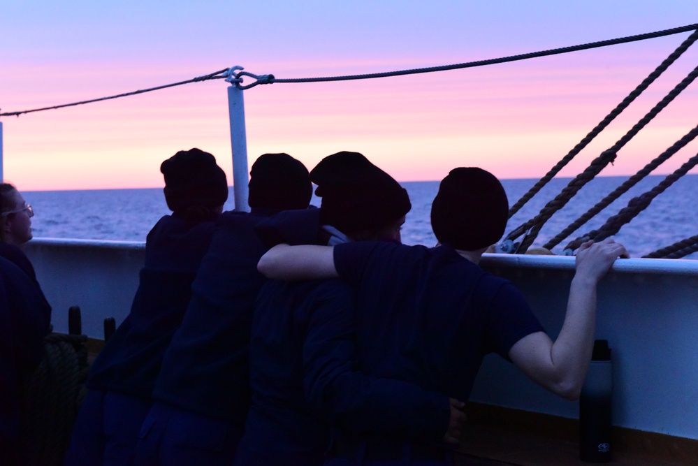 Coast Guard personnel aboard USCGC Eagle enjoy twilight while underway in the Atlantic Ocean