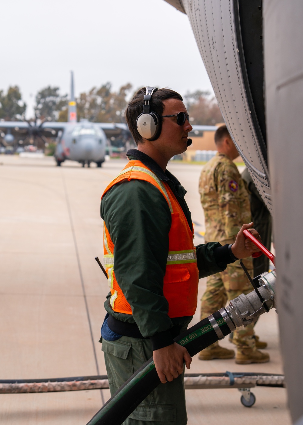 Joseph Matte with the U.S. Forest Service charges a Modular Airborne Fire Fighting unit during 2023 MAFFS spring training