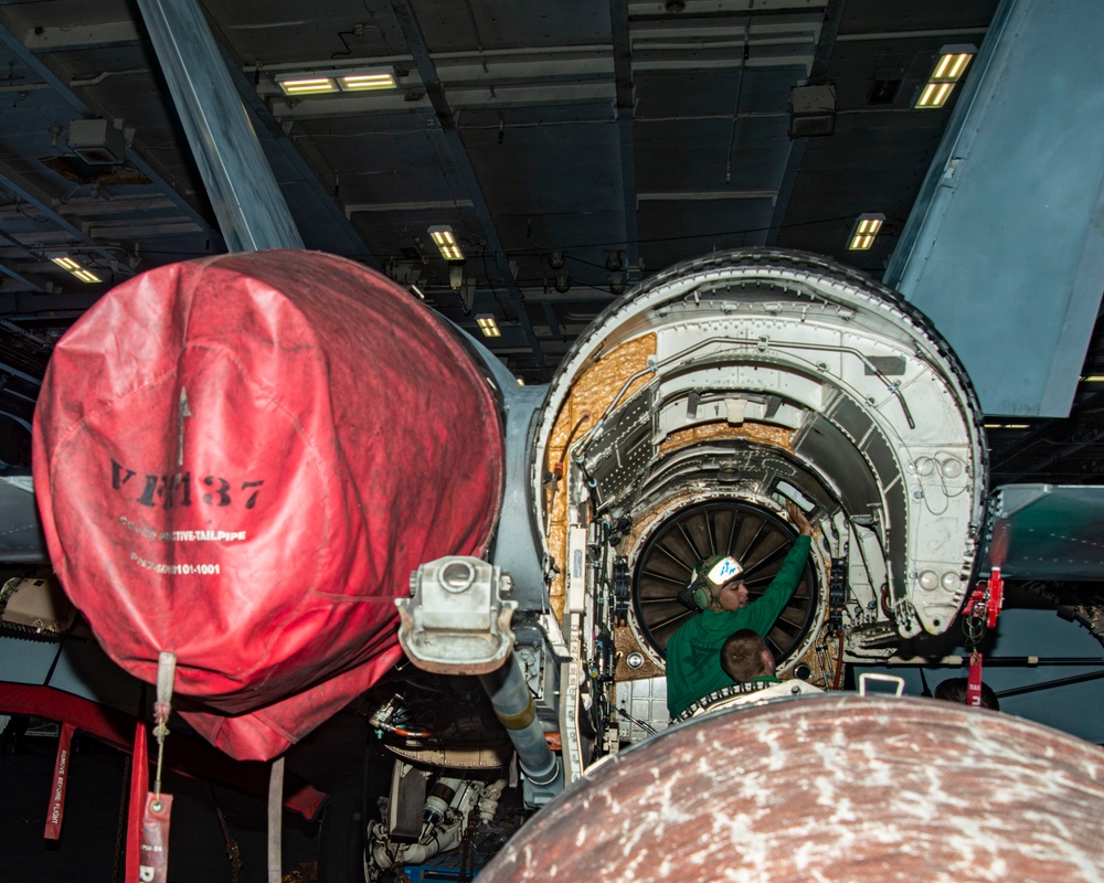 Sailor Inspects Engine Cavity Interior