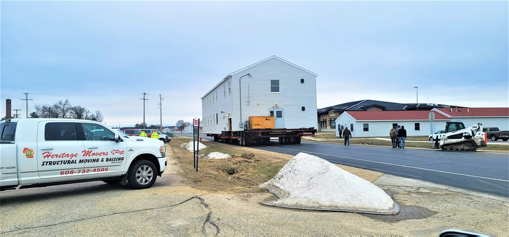 Continuing making history: Contractors move last two World War II-era barracks to new locations